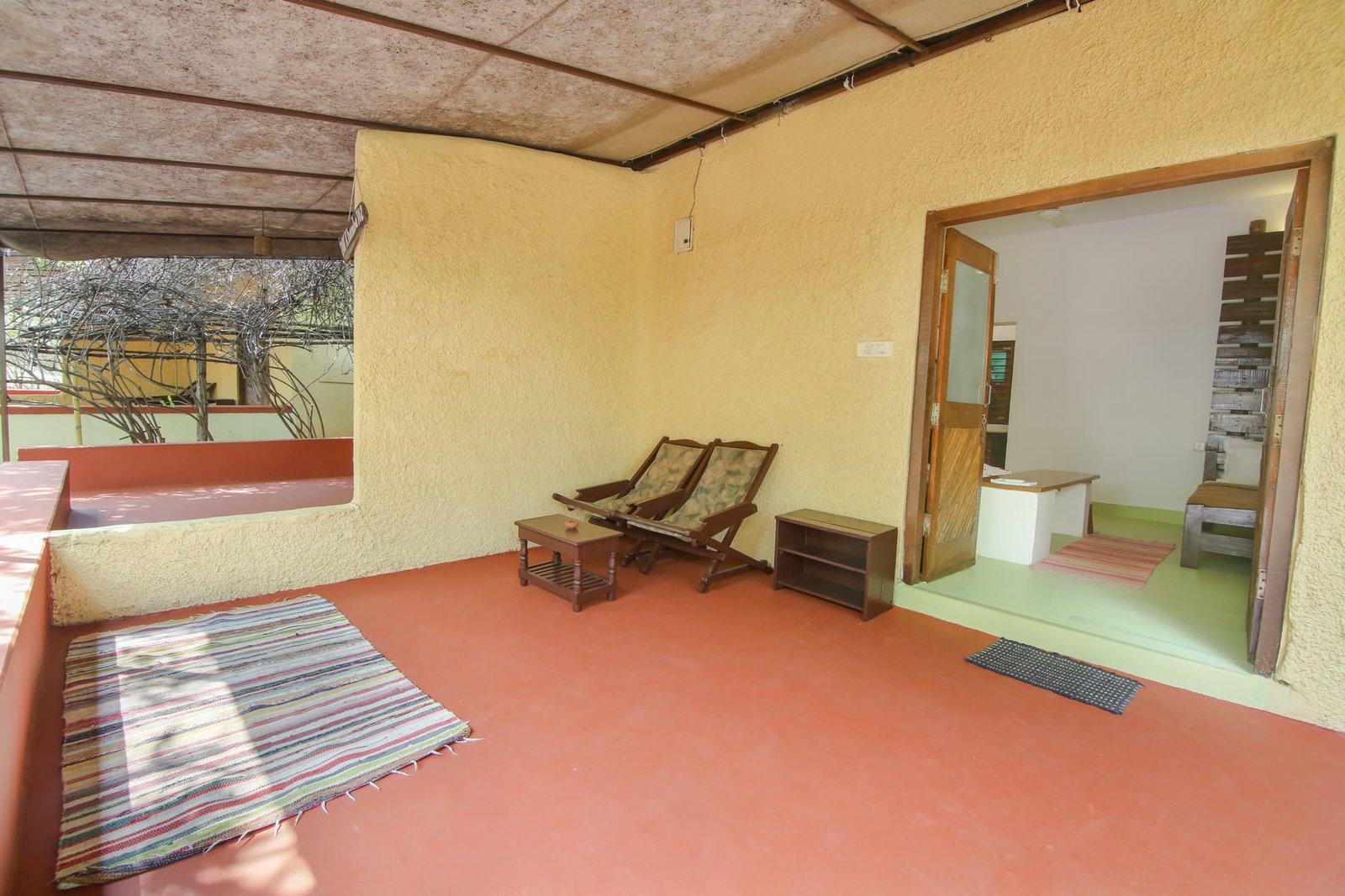 Cottage verandah seating area with lush nature view